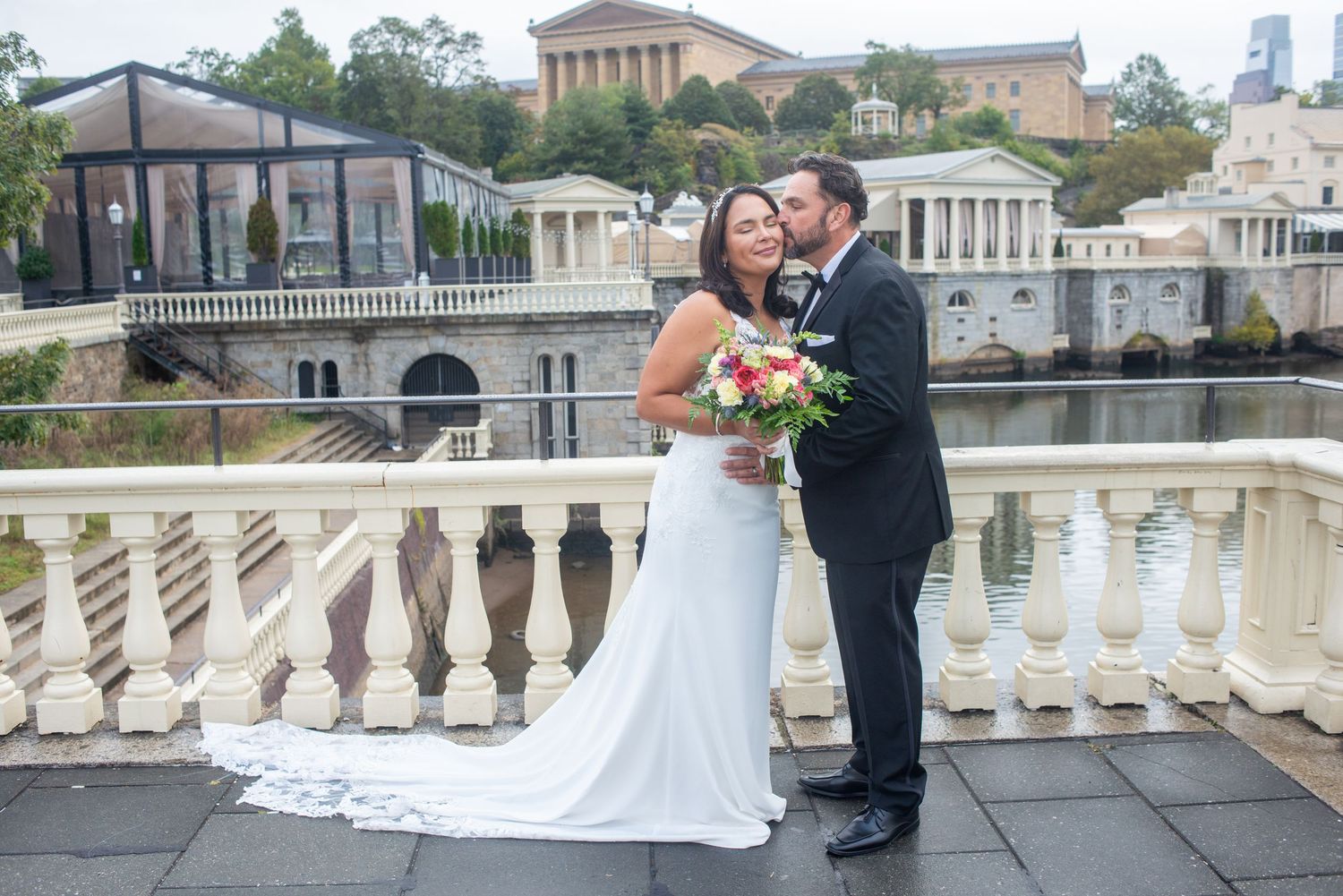 A couple shares their first dance as newlyweds in front of the iconic Philadelphia Art Museum and water fountains.
