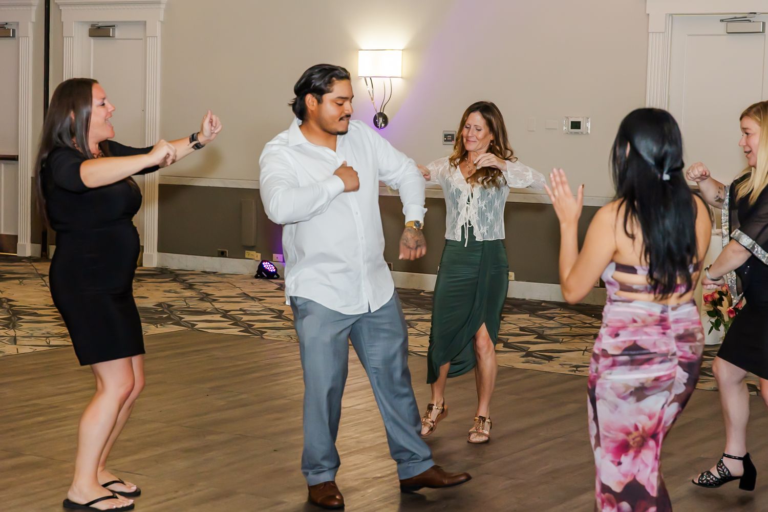 Guests enjoying a lively dance party in a spacious indoor venue with modern decor.