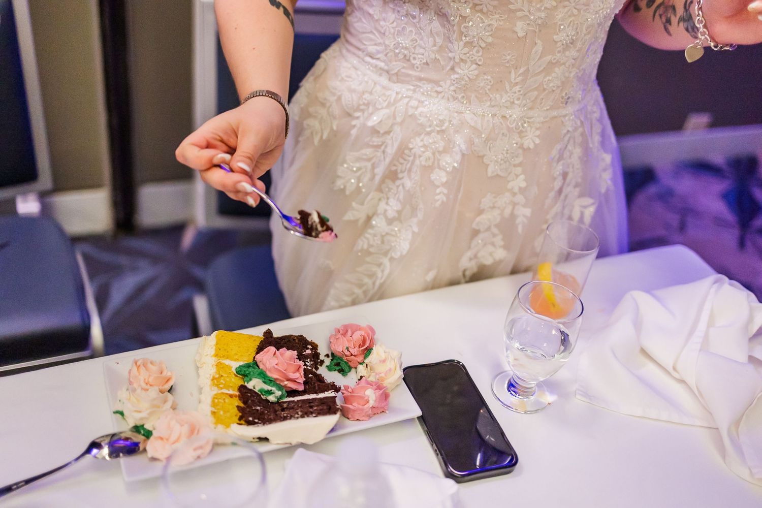 Close up details of an ornate white lace wedding dress during the reception.