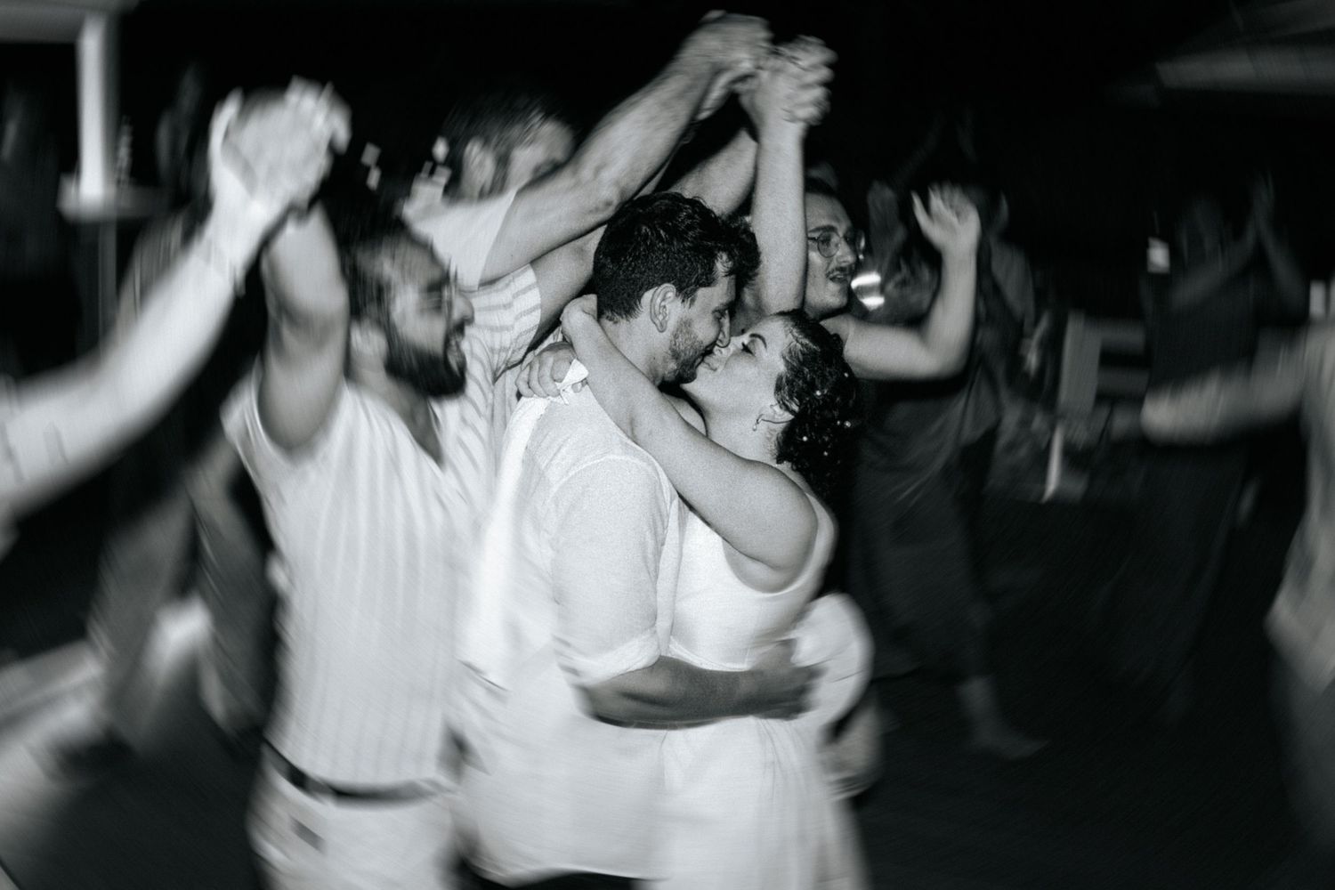 A series of black and white photographs showing people dancing energetically at what appears to be a nightclub or party.
