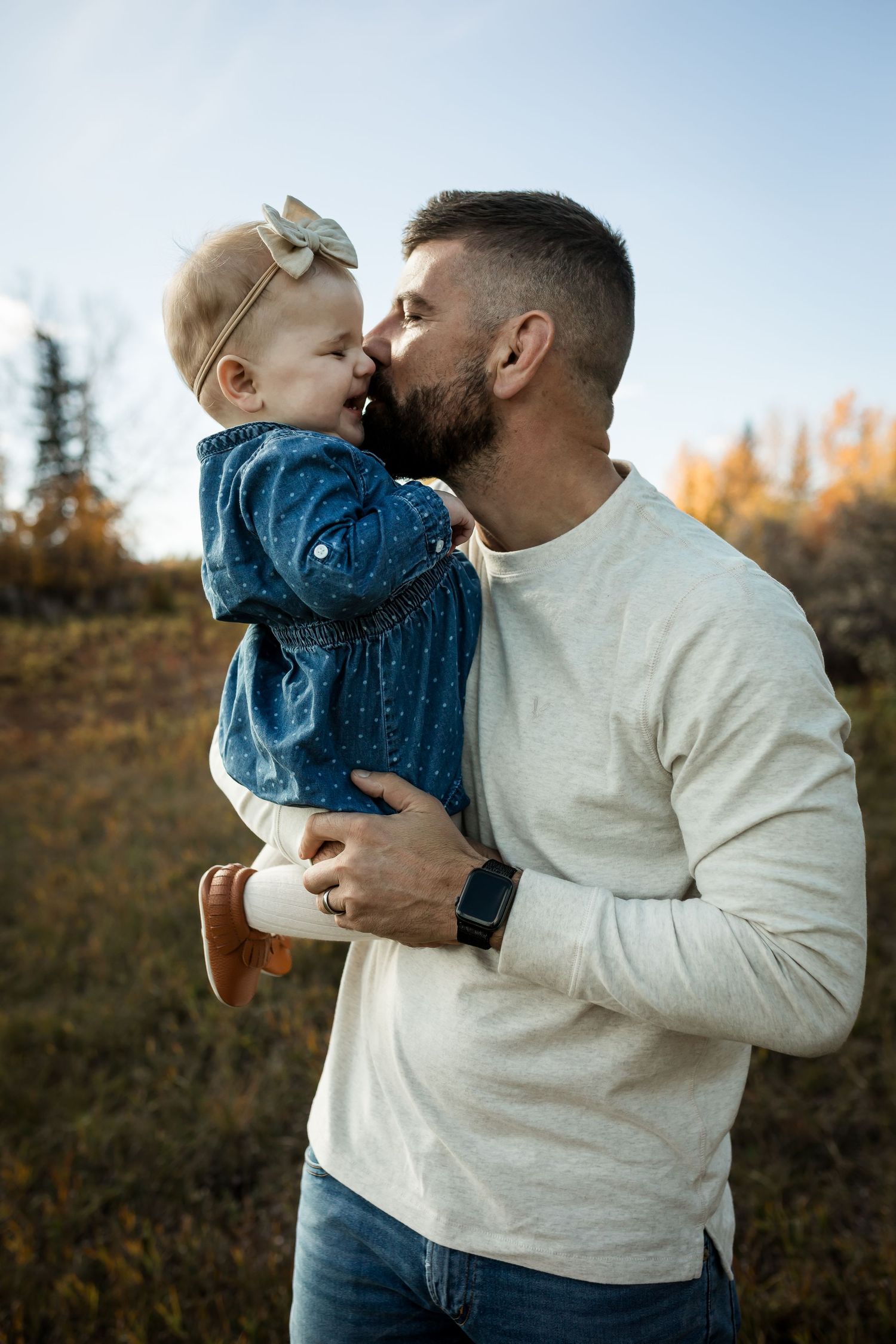 Father daughter moment: Lifestyle fall family photos at Fish Creek Park in Calgary.