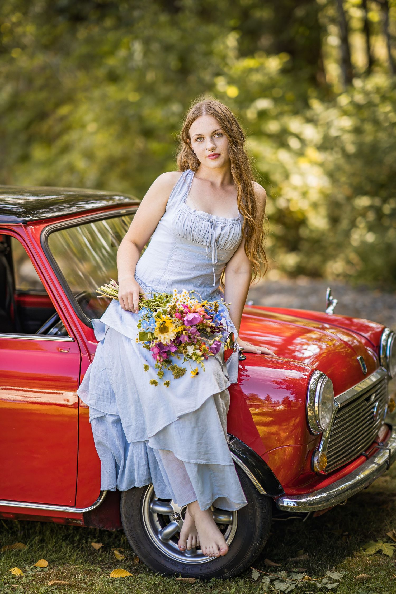 styled photography senior mini session with red classic mini Cooper car and seasonal flowers