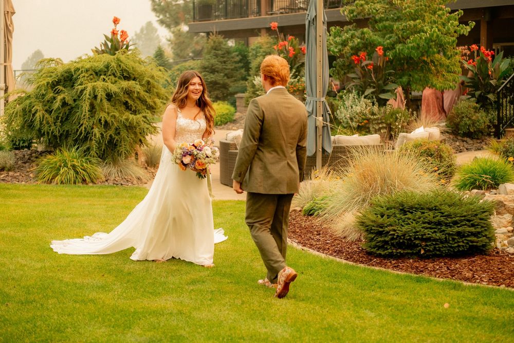 Couple walking on landscaped garden path during their wedding photoshoot.