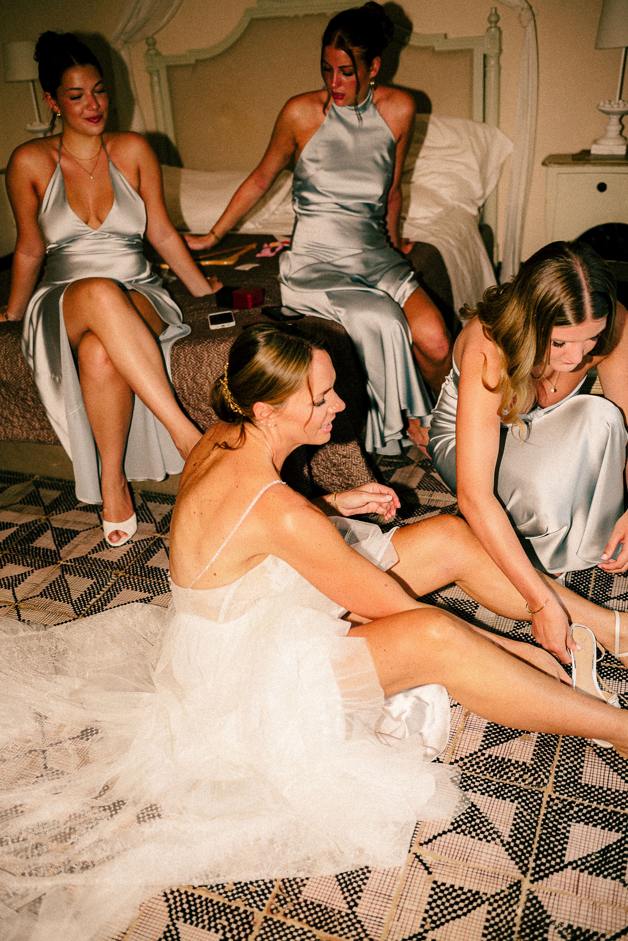 Group of friends in formal attire relaxing together during a wedding celebration.