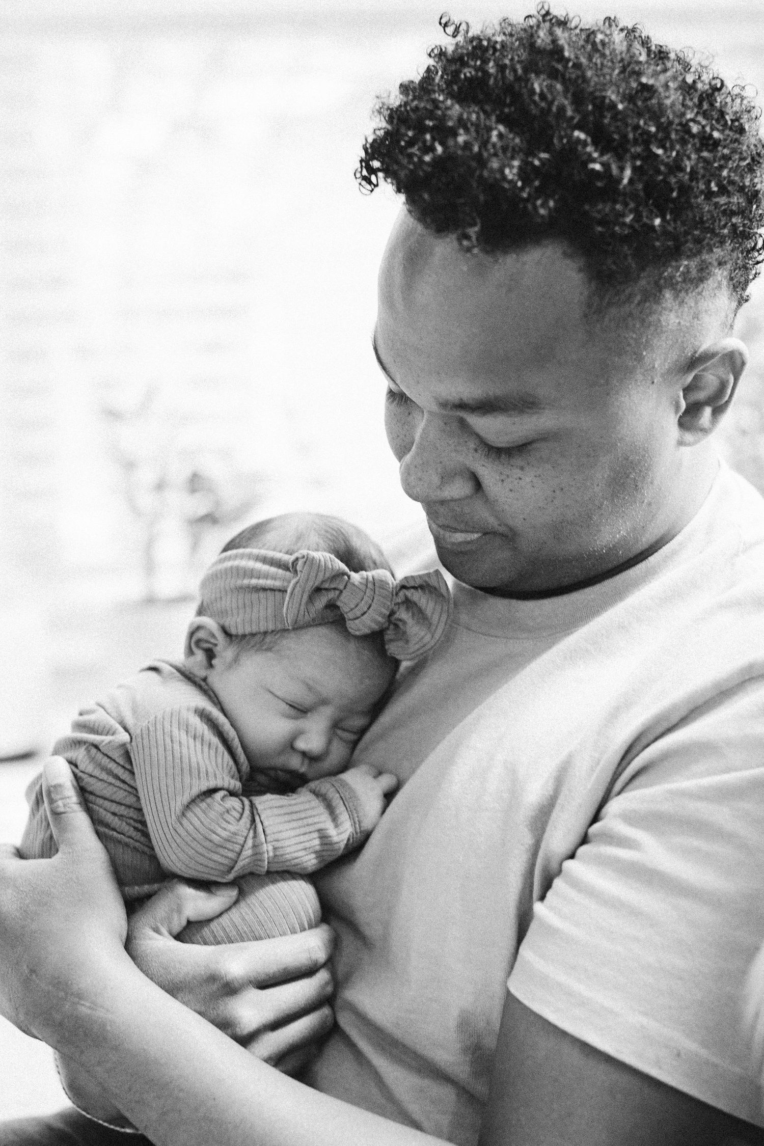 Black and white images of tender moments between parent and baby.
