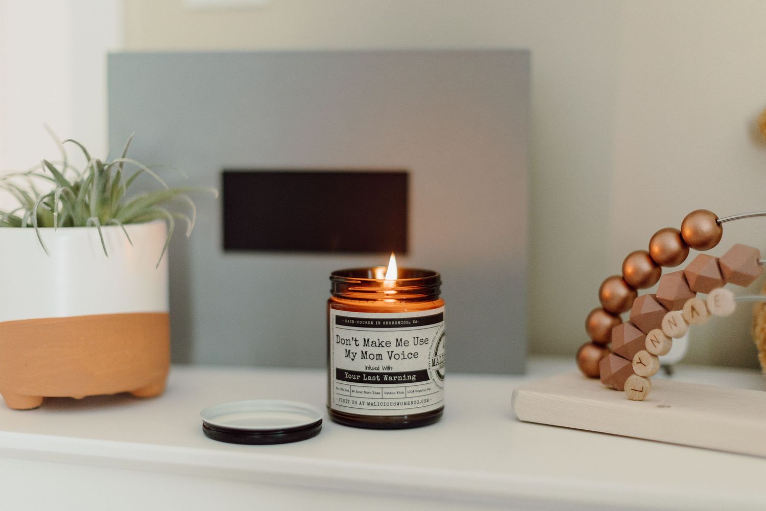 Minimalist shelf arrangement with candles and natural decor items.