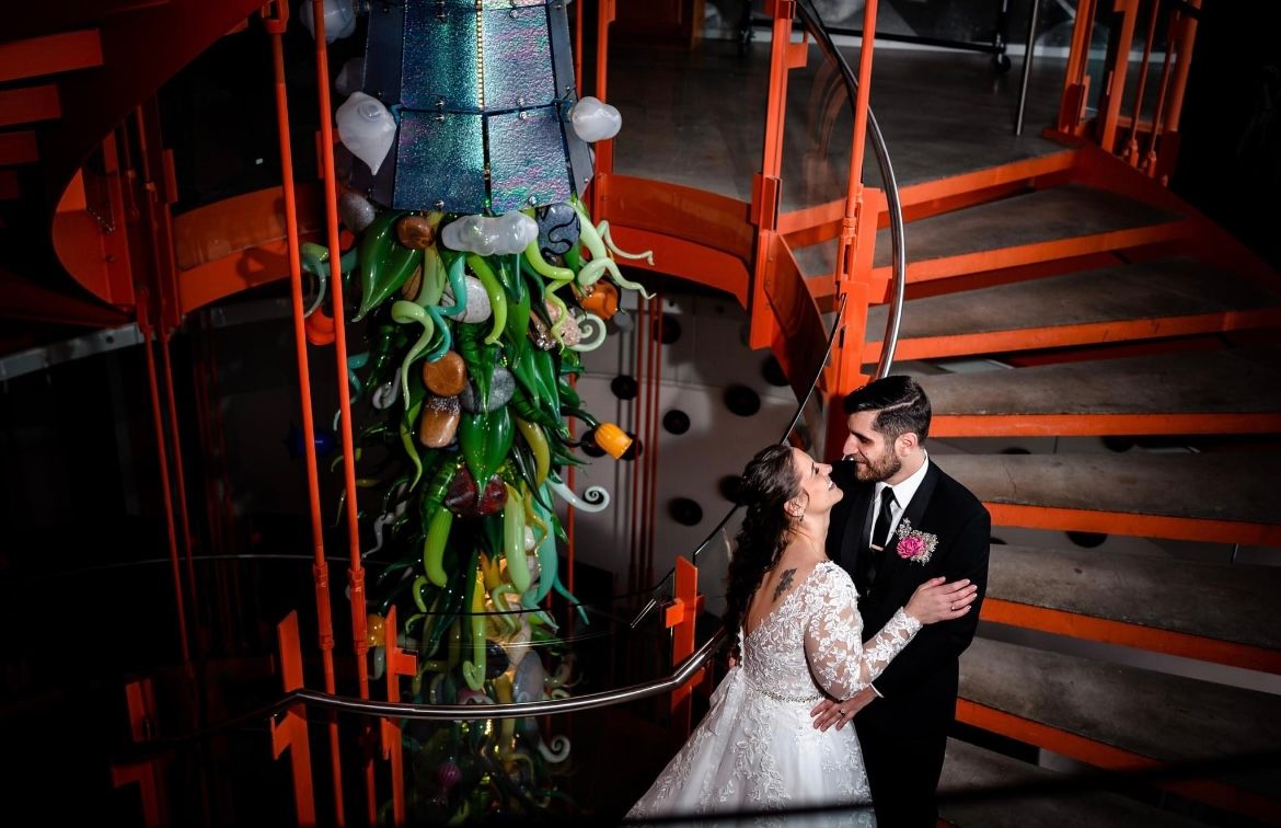 Dramatic red-lit wedding photos captured on vintage industrial stairs.