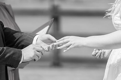 Black and white image series showing hands exchanging rings during a wedding ceremony.