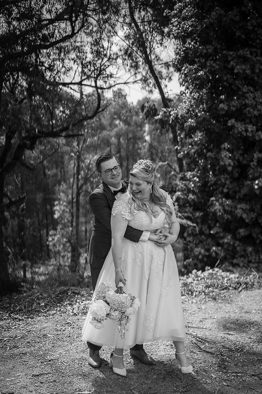 Black and white photo series showing a tender family moment shared between loved ones in a peaceful woodland setting.