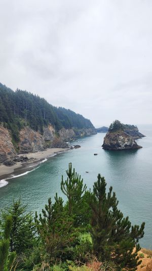 River gorge with cliffs and a rocky island in the water.