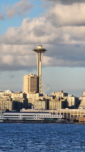Seattle Space Needle with cloudy skies above Elliott Bay.