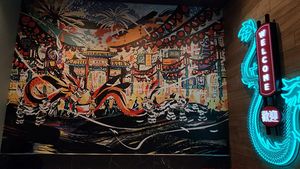 Colorful wall mural with abstract designs and a large painted guitar.