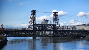 Steel bridge over Willamette River in Portland on a sunny day.