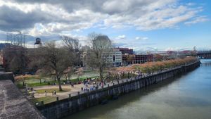 Portland waterfront promenade with trees and a cloudy blue sky.