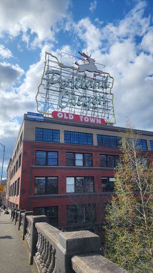 Historic Portland stag sign with cloudy blue sky.