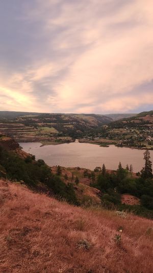 Sunset view over Columbia River Gorge with glowing sky.
