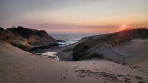 Sunset over sand dunes at the Oregon Coast.