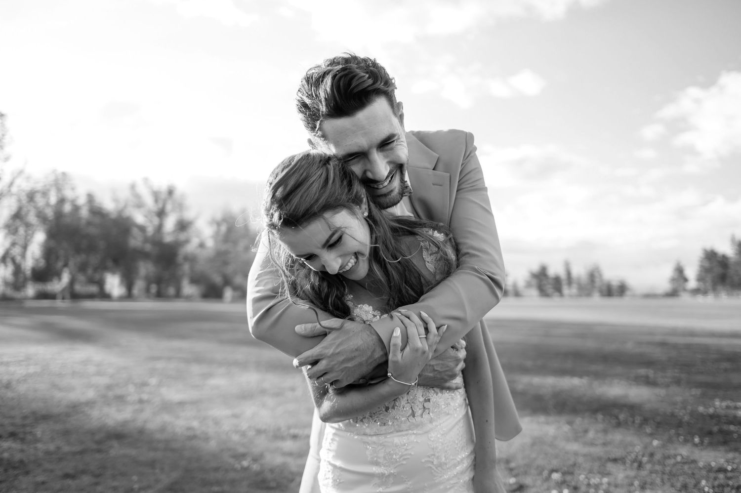 Black and white wedding photography captures intimate moments on a sunny day.