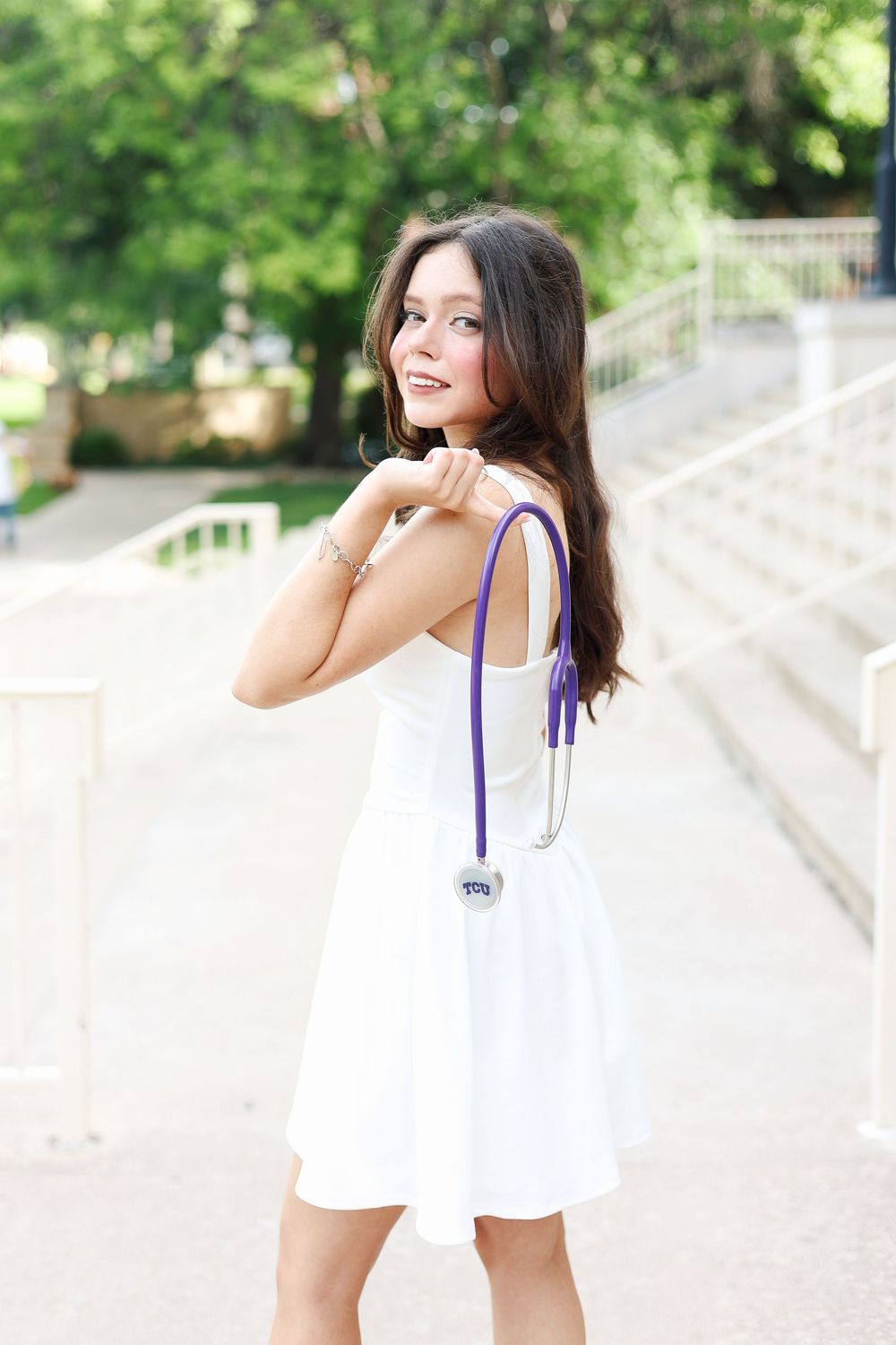 Bright summer portraits captured along white stone steps in natural lighting.