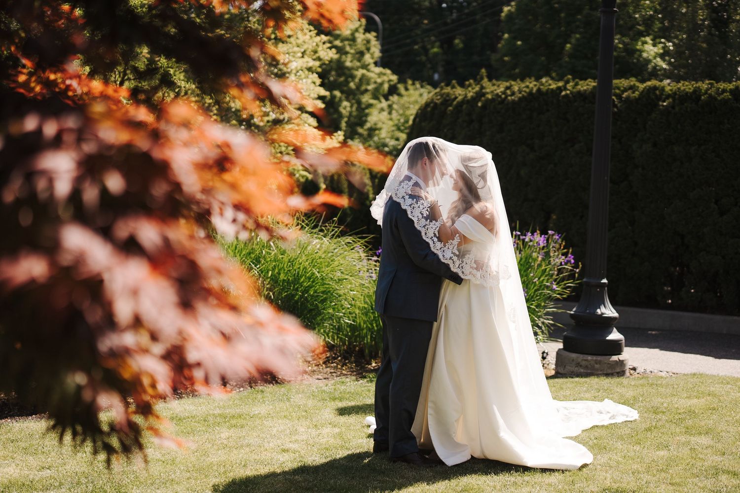 A romantic garden wedding scene with figures embracing under autumn foliage, creating a dreamy outdoor atmosphere.