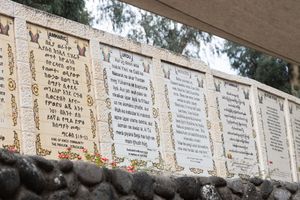 Photo of bible verses etched in stone in different languages at the Jordan River in Israel