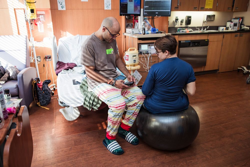 Hospital room interior showing medical equipment and birthing ball.