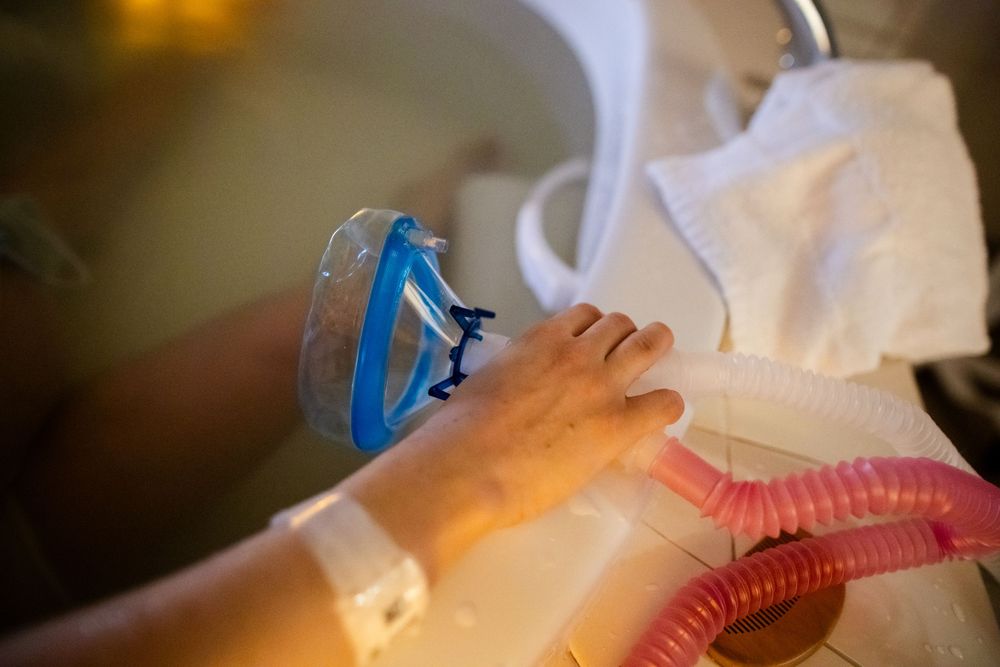 Medical equipment and tubes in a hospital room with warm lighting.