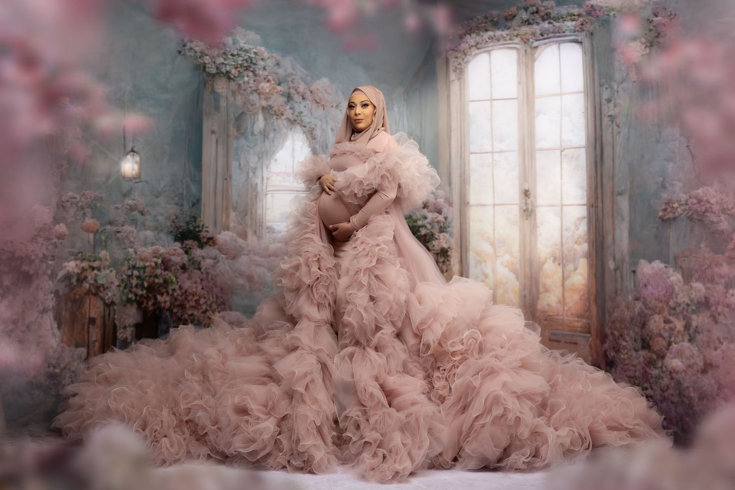 A dreamy fashion portrait in a pink ruffle gown surrounded by cherry blossoms in an ethereal indoor setting with natural light.