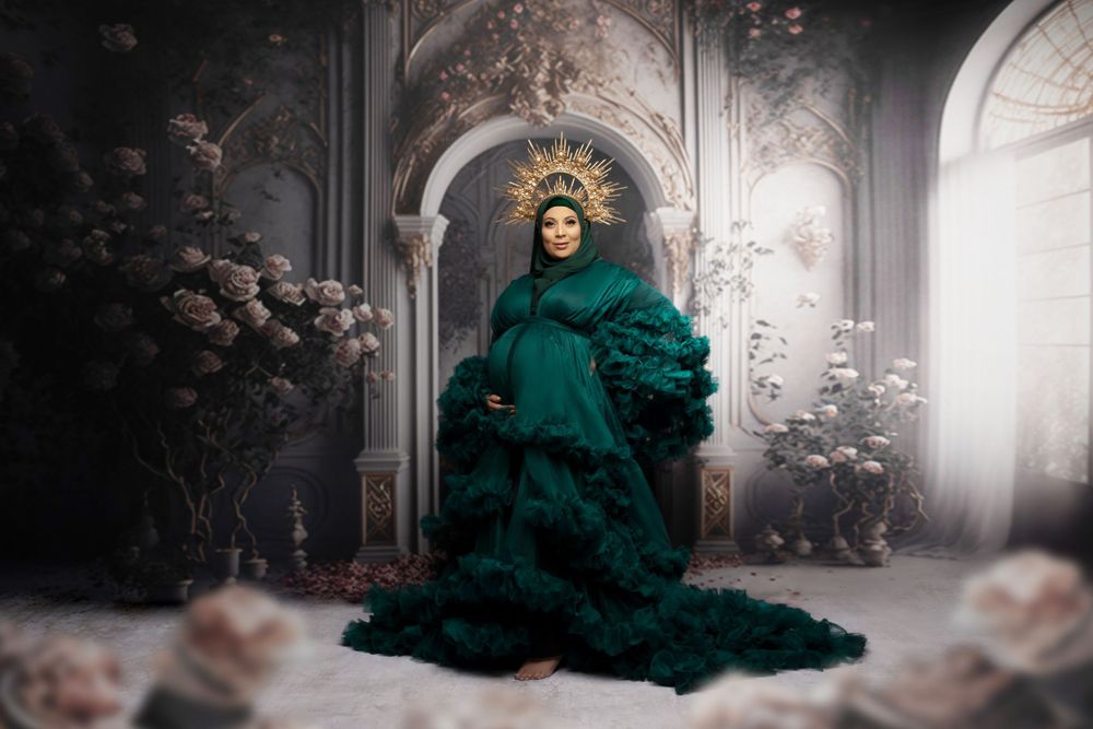 A dramatic emerald green ruffled gown fills an ornate archway in a misty, romantic setting with soft lighting.