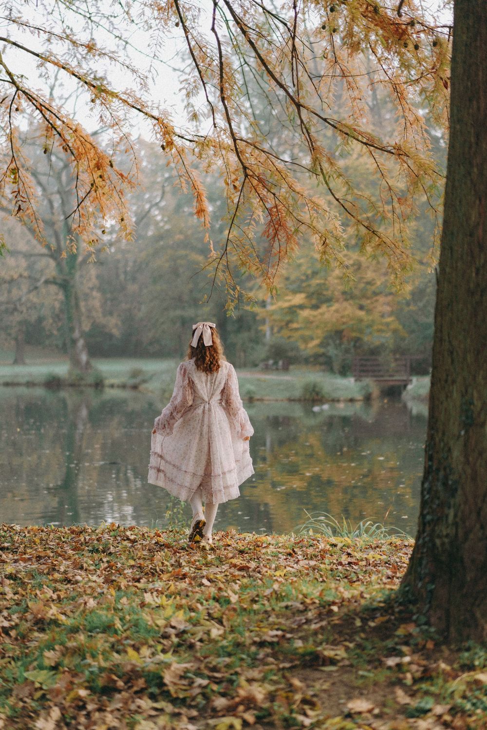 Girl walks towards stream in a park. Maximir park Zagreb, Family documentary photography