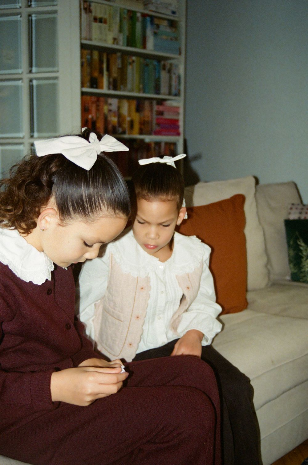 Sisters interacting seated on a sofa, Zagreb family photo session