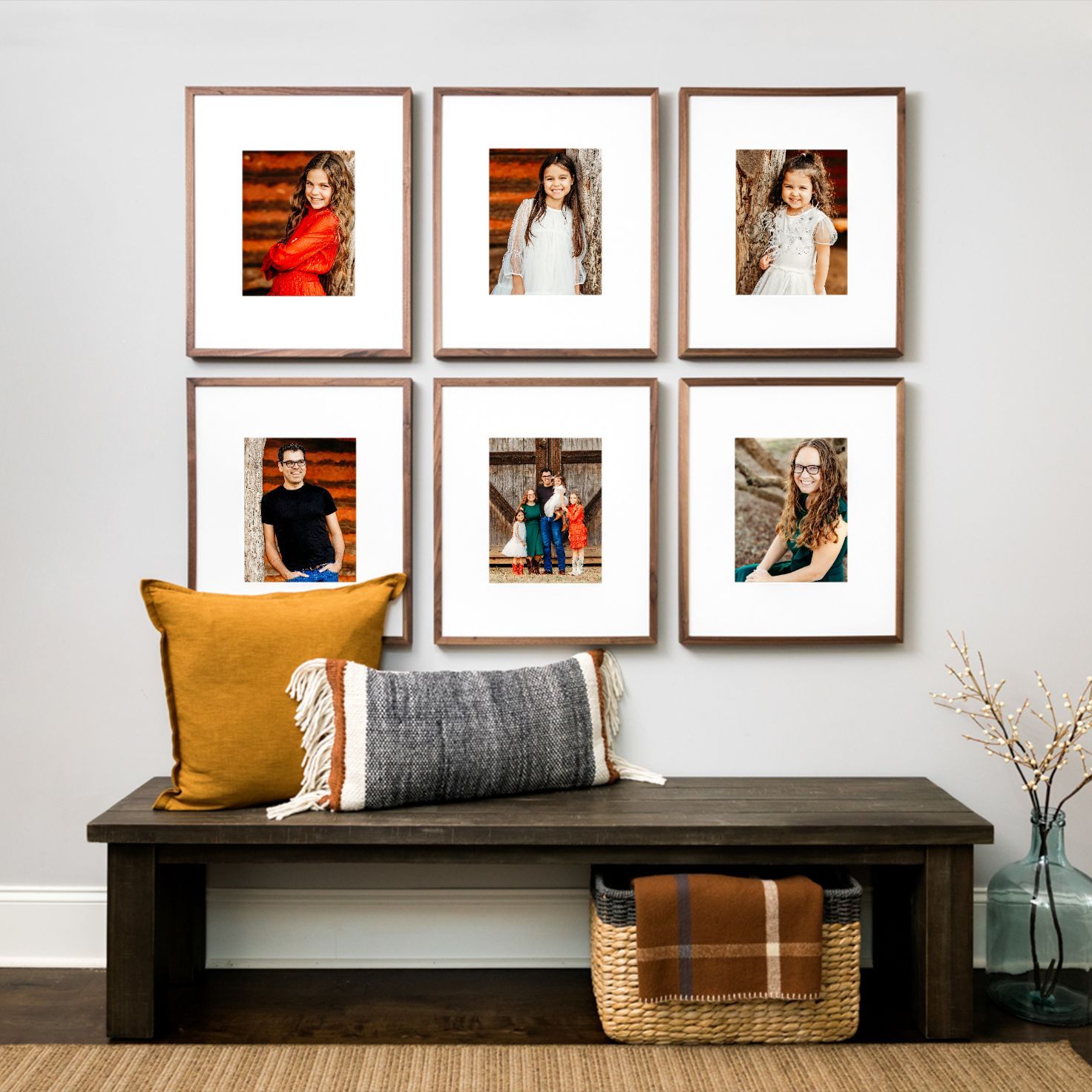 A modern living room interior with framed artwork and minimalist decor on a dark entry bench in Southlake, TX