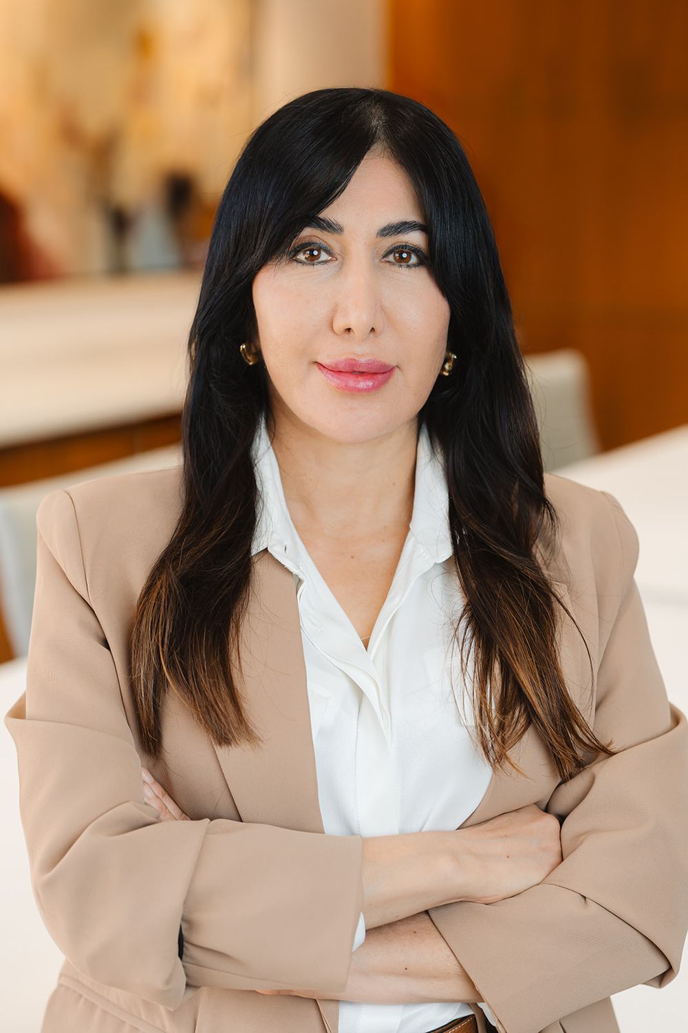 Professional portrait series showing person in beige blazer and white shirt against warm office background.