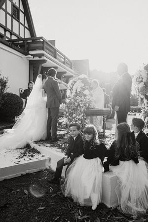 Black and white wedding ceremony photo sequence showing a couple walking together in five progressive frames.