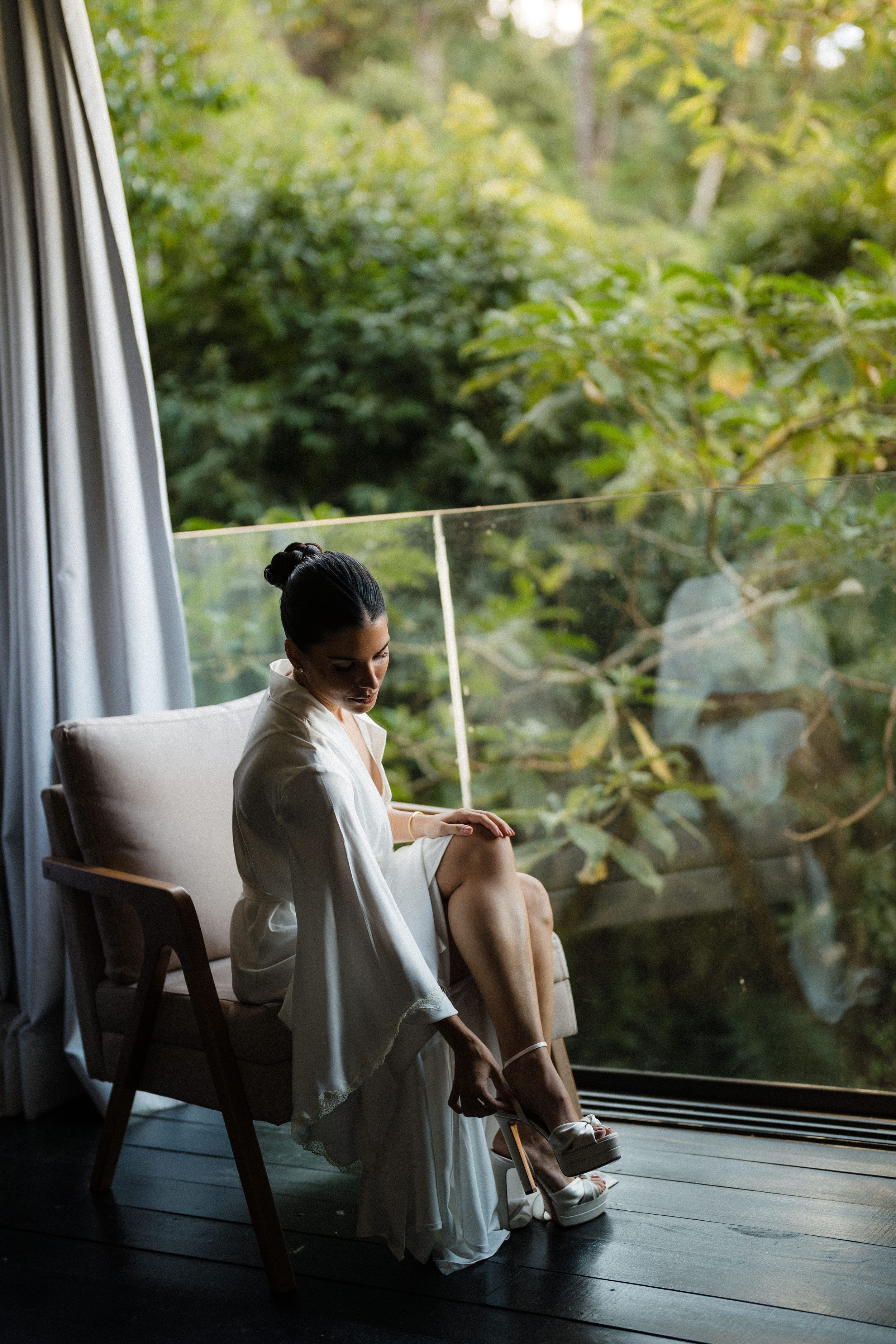 A series of artistic black and white photographs showing a figure by a window in contemplative poses.