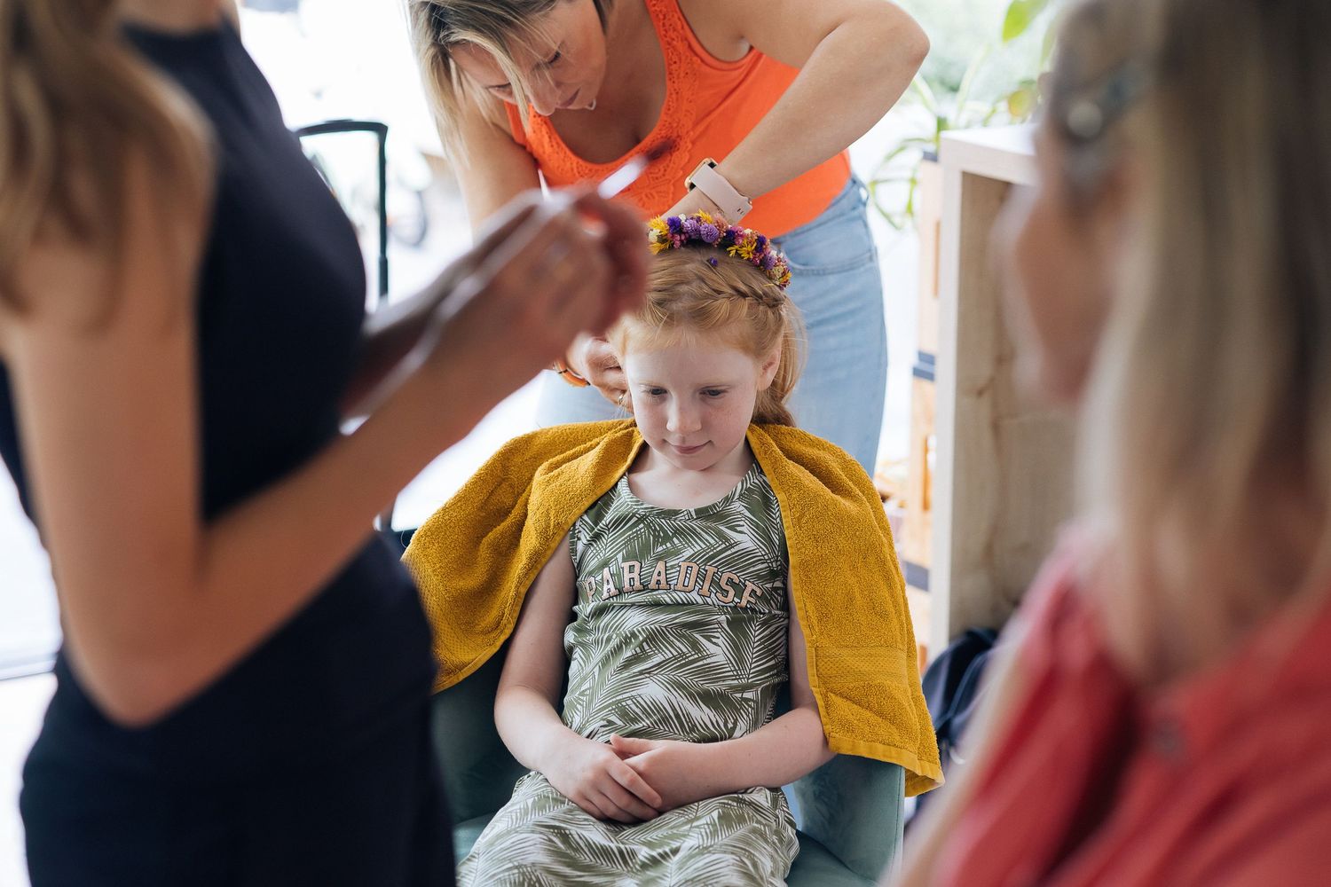 People styling hair in a relaxed home setting.