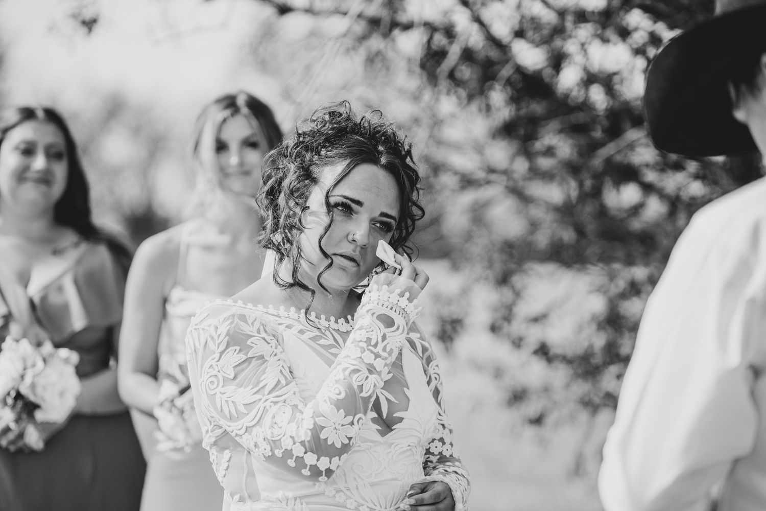 A loving couple shares a romantic moment during their engagement session in a sunny outdoor setting.