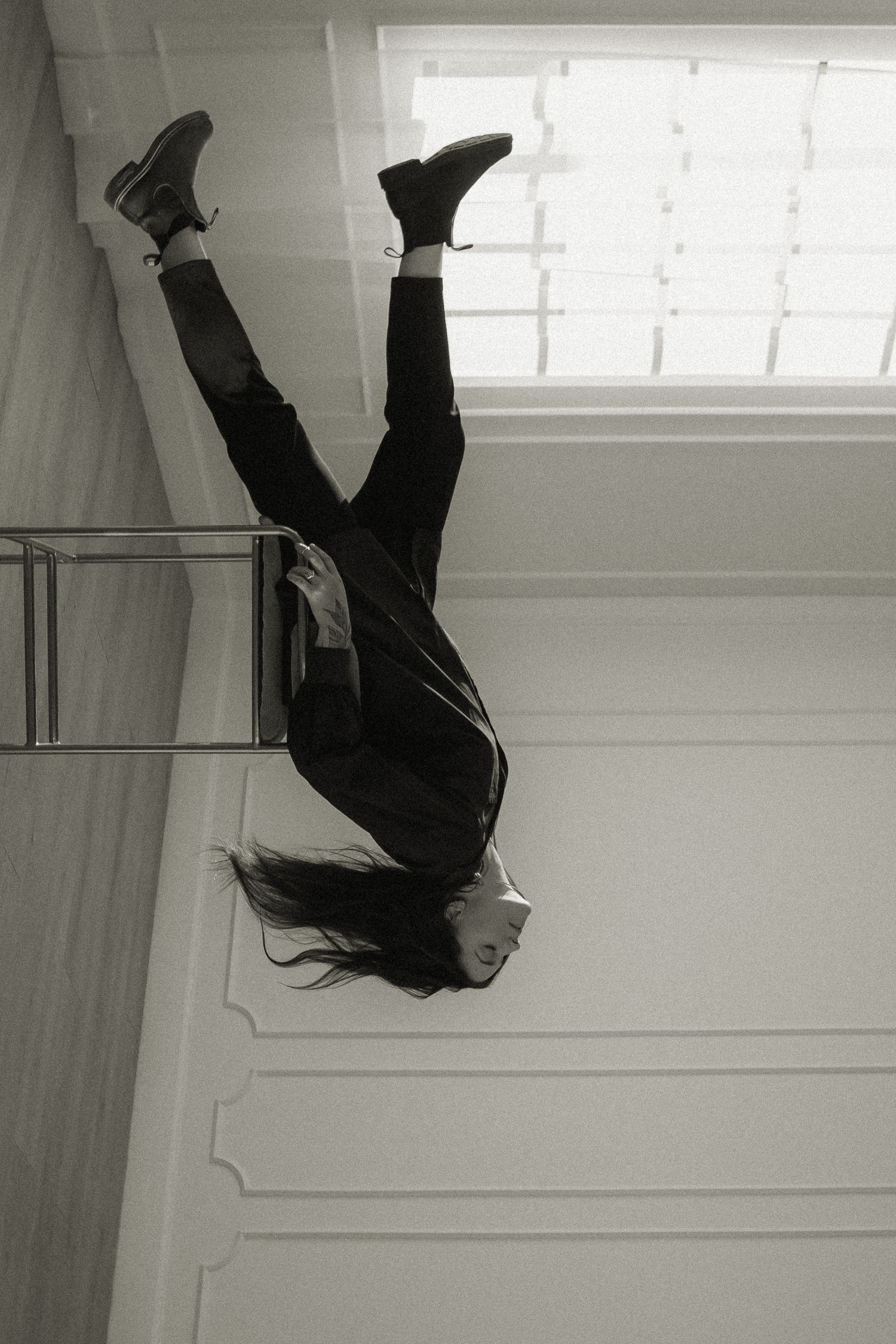 Dramatic upside-down black and white portrait showing long hair cascading down.