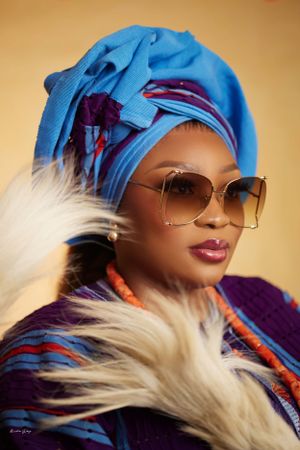 Stylish portraits featuring blue headwear, blonde hair, and sunglasses with dramatic lighting.