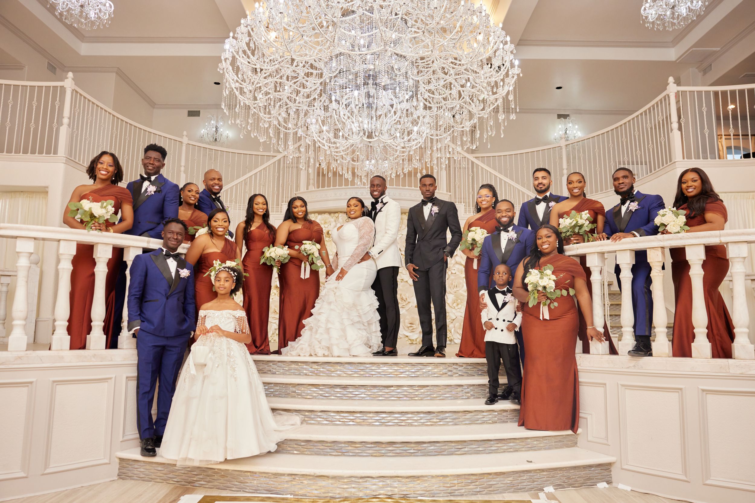 Elegant wedding reception in a grand ballroom with crystal chandeliers and formal table settings.
