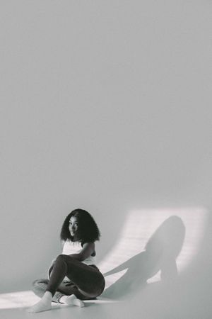 Minimalist black and white photo sequence showing a solitary figure in various poses.