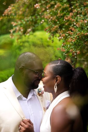 Romantic outdoor couple's portrait under blooming spring trees.