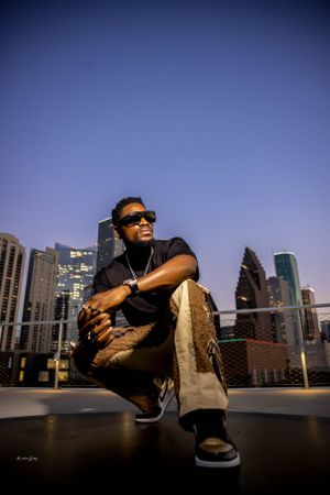 Urban rooftop photo session with city skyline backdrop at dusk.