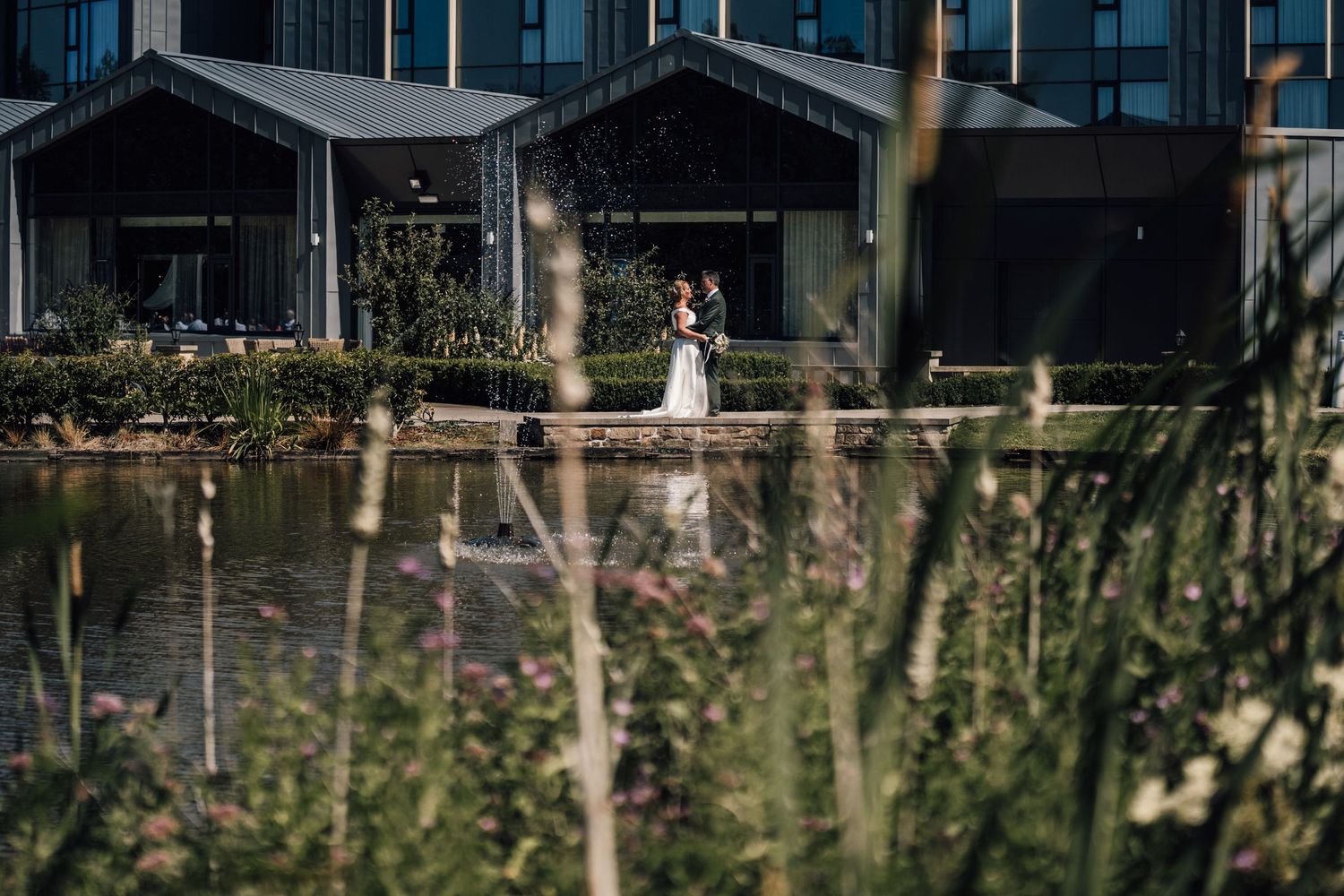 Modern waterfront venue with glass windows reflecting evening light.