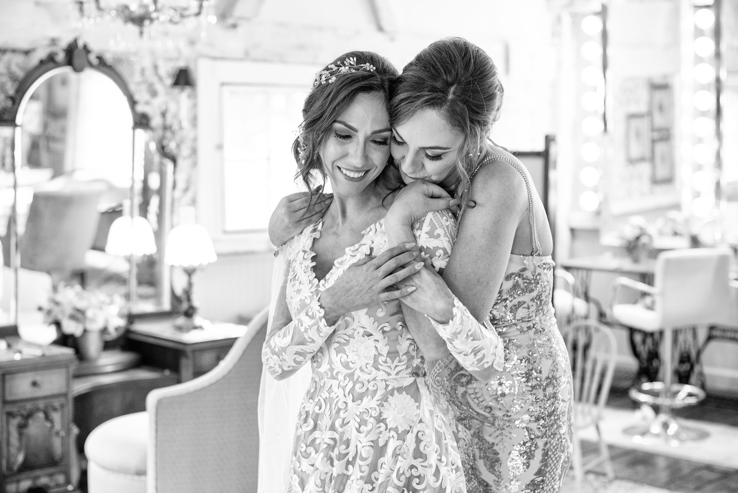 Black and white wedding preparation moments in natural window light.