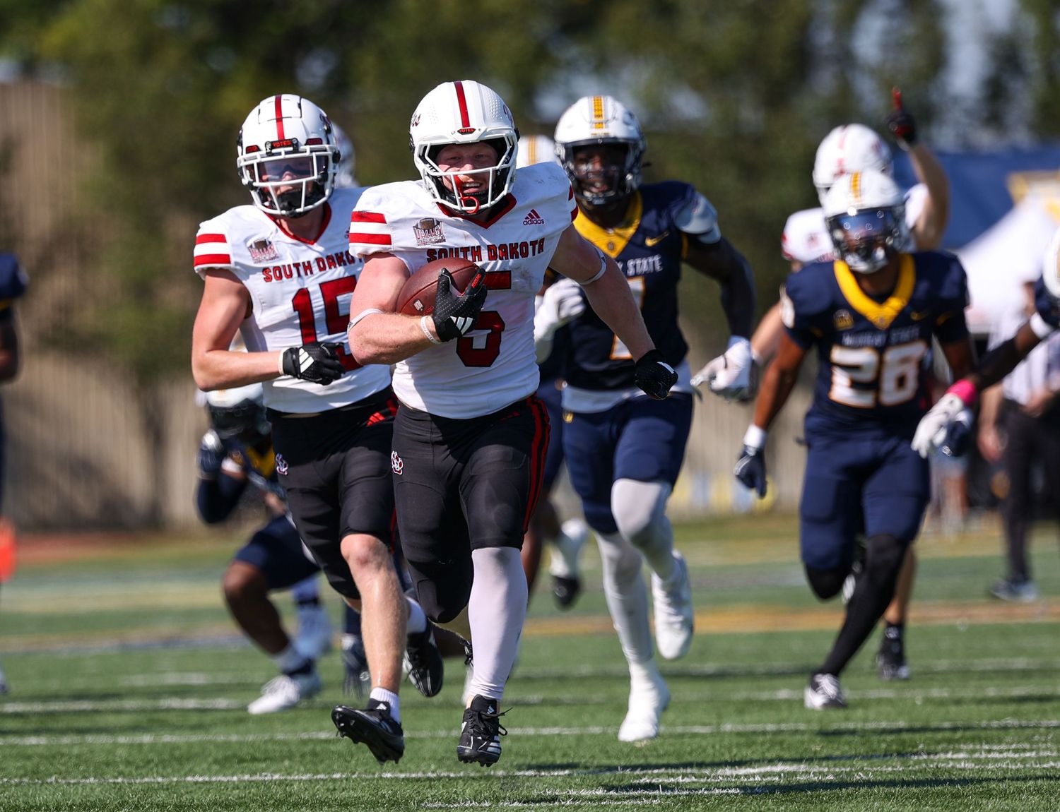 Runinng back pulling away from defenders