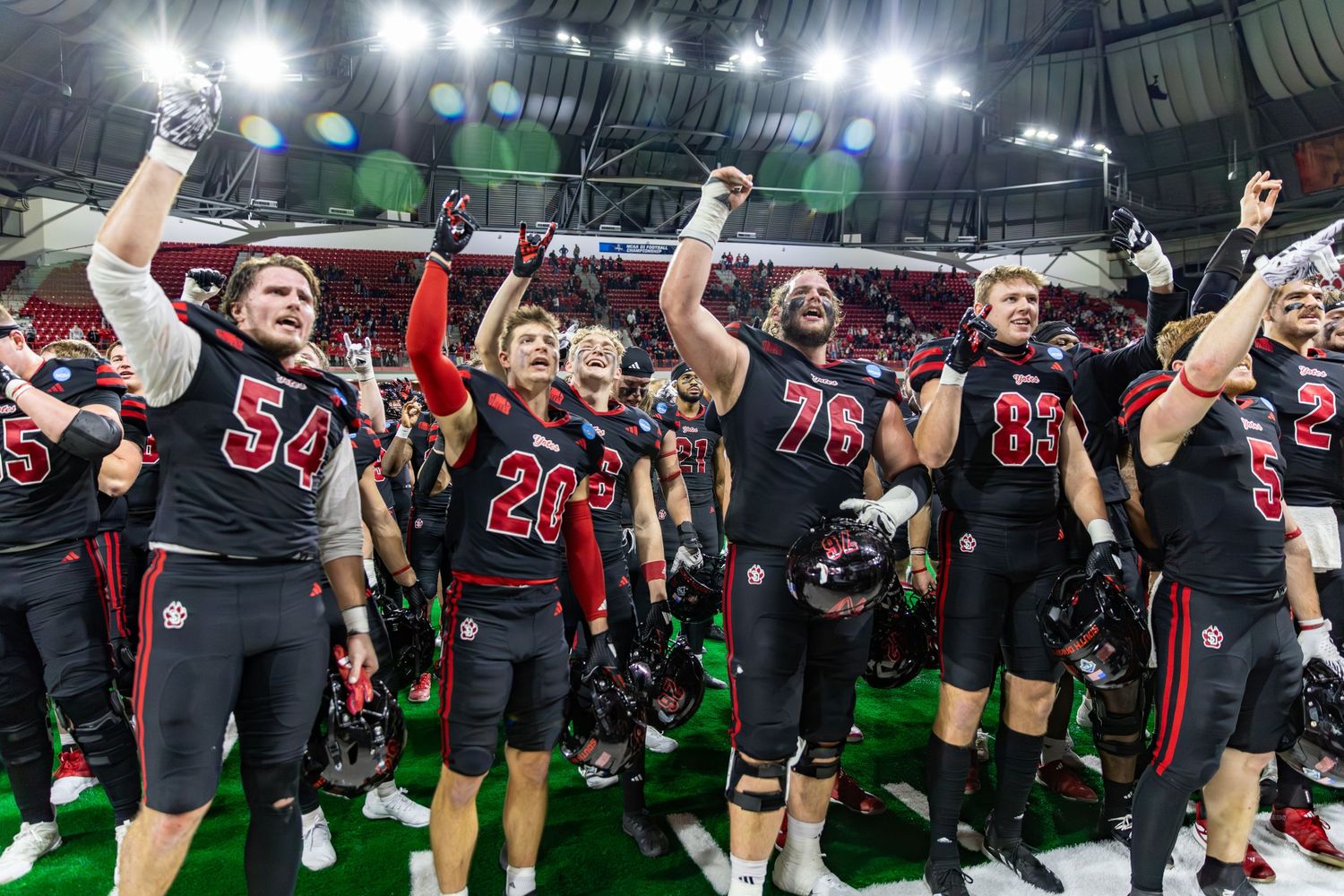 Group of University of South Dakota Football players celebrating a victory