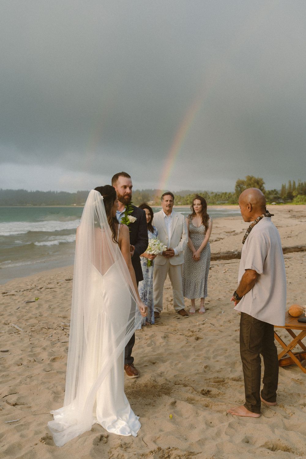 Elopement ceremony under rainbow at Hanalei Bay