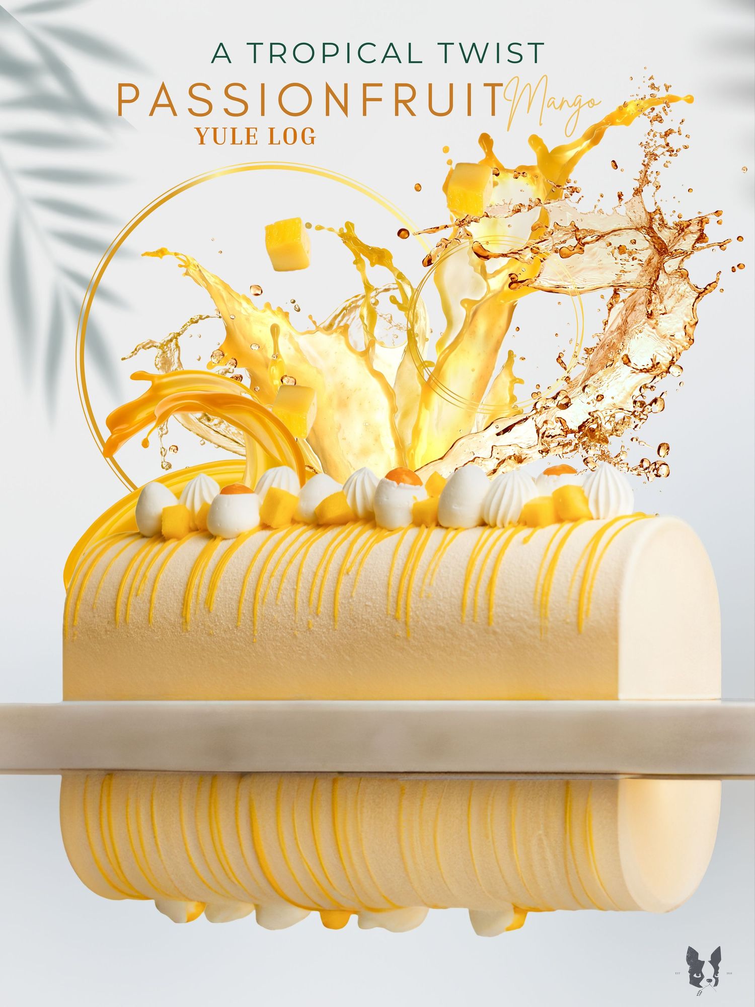 A passionfruit mango yule log cake with tropical fruit splash decoration and gold ring accent.
