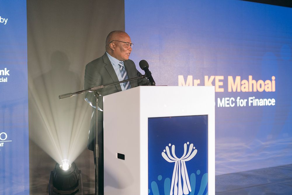 Mr KE Mahoai, MEC for Finance, delivering speech at formal podium event.